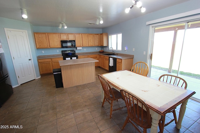 2434 E San Manuel Rd, San Tan Valley, AZ 85143 - kitchen featuring a sink, dark tile patterned floors, black appliances, light countertops, and a center island