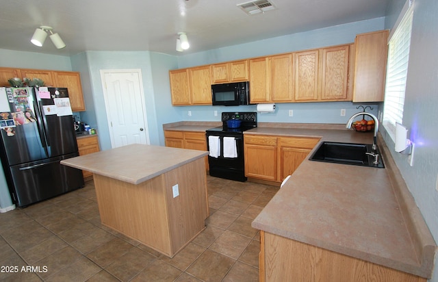 2434 E San Manuel Rd, San Tan Valley, AZ 85143 - kitchen with a center island, visible vents, a sink, black appliances, and light countertops