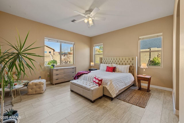 bedroom featuring baseboards, ceiling fan, and visible vents