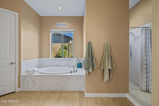 bathroom featuring a garden tub, wood finished floors, and a shower with curtain