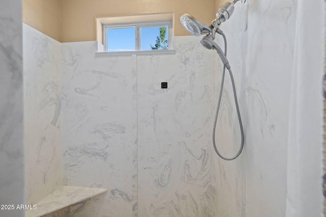bathroom featuring a marble finish shower