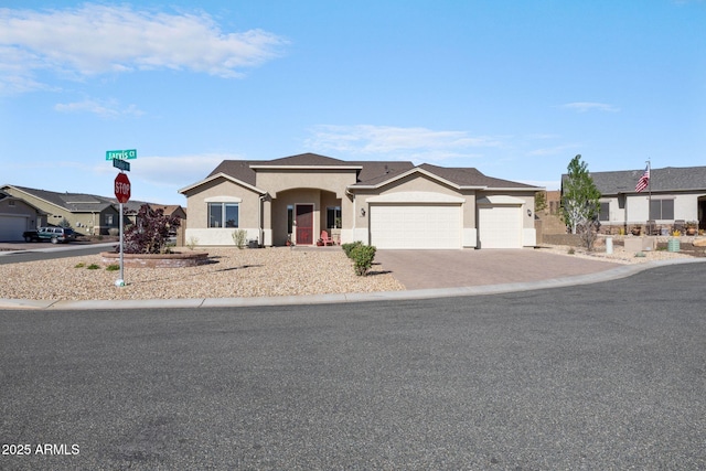 ranch-style home featuring stucco siding, driveway, and a garage