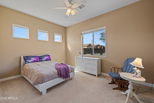 carpeted bedroom featuring visible vents, baseboards, and multiple windows