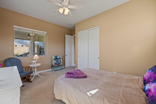 carpeted bedroom featuring baseboards, a ceiling fan, and a closet