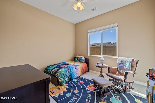 carpeted bedroom with baseboards, a ceiling fan, and visible vents