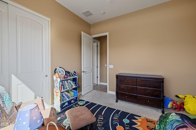 carpeted bedroom featuring baseboards, a ceiling fan, and visible vents