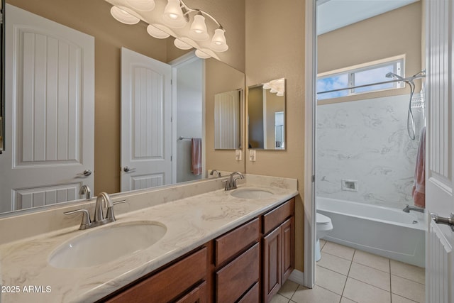 bathroom with double vanity, a sink, tile patterned floors, and toilet