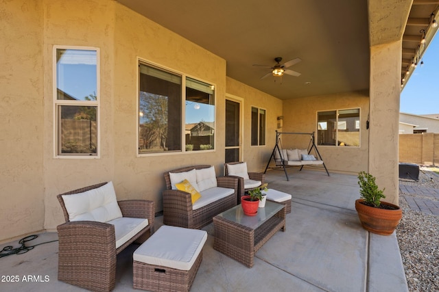 view of patio with an outdoor living space, ceiling fan, and fence