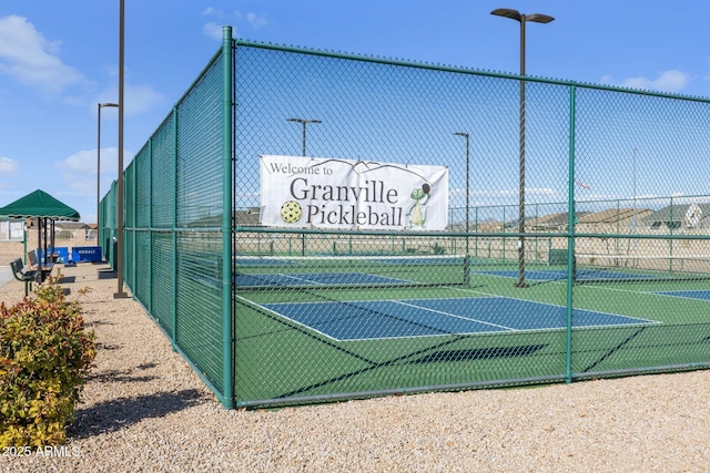 view of sport court featuring fence