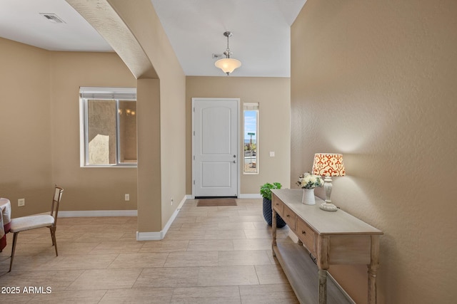 entryway featuring visible vents, baseboards, and a healthy amount of sunlight