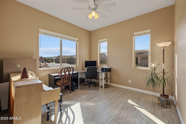 office area with baseboards, a ceiling fan, and wood finish floors