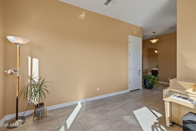 interior space featuring baseboards and visible vents
