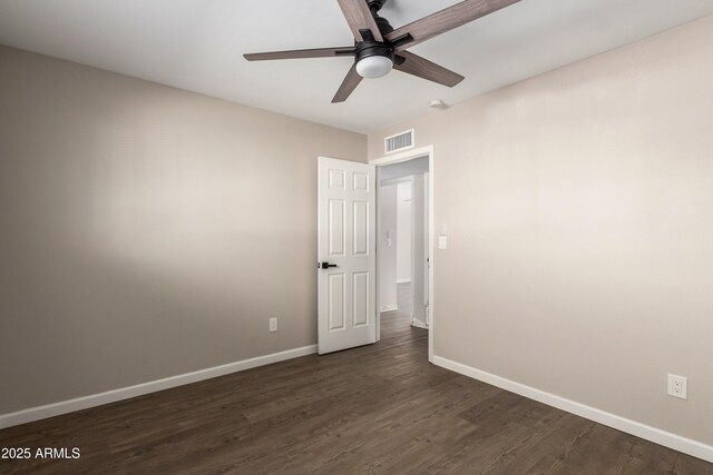 spare room with ceiling fan and dark hardwood / wood-style floors