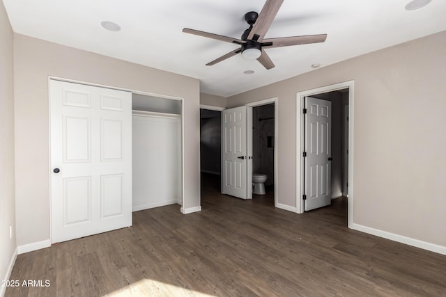 unfurnished bedroom with ensuite bath, ceiling fan, a closet, and dark hardwood / wood-style floors