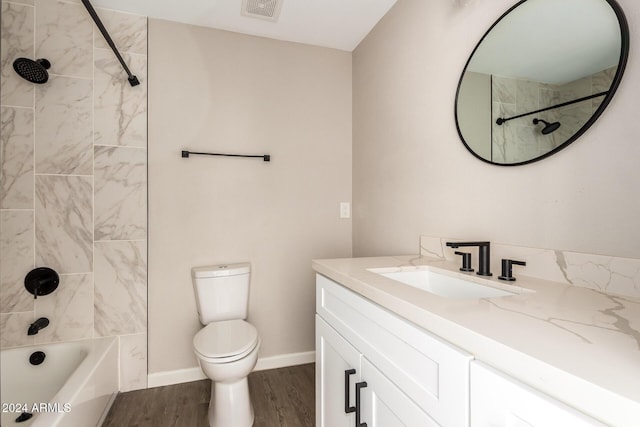 full bathroom featuring wood-type flooring, vanity, toilet, and tiled shower / bath