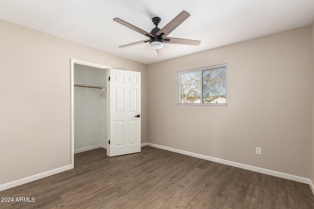 unfurnished bedroom featuring ceiling fan, dark wood-type flooring, and a closet