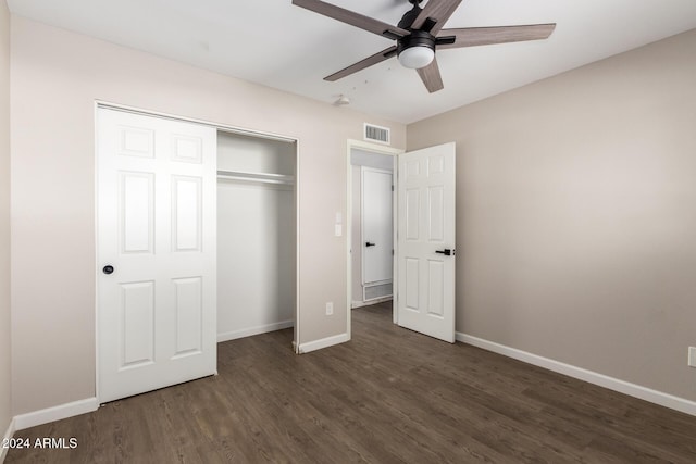 unfurnished bedroom featuring ceiling fan, dark hardwood / wood-style flooring, and a closet