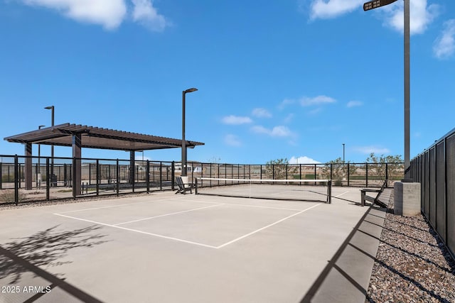 view of tennis court featuring fence