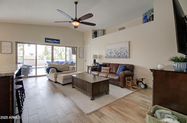 12041 S 45th St, Phoenix, AZ 85044 - living room with light wood-style floors, high vaulted ceiling, visible vents, and a ceiling fan