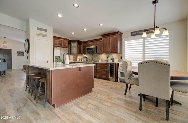 12041 S 45th St, Phoenix, AZ 85044 - kitchen featuring light wood-style flooring, wine cooler, lofted ceiling, and stainless steel appliances
