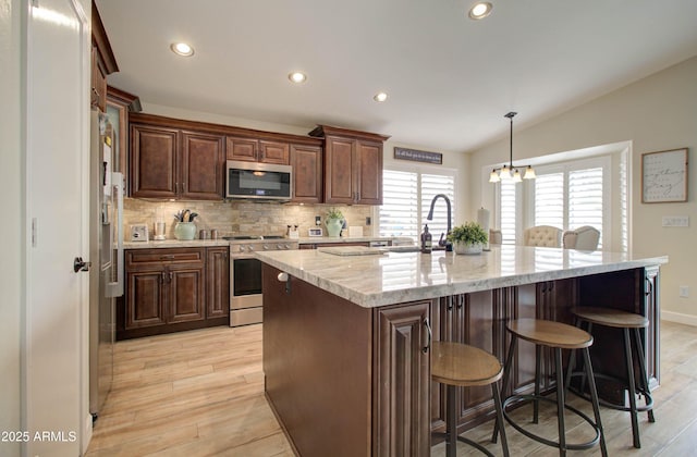 12041 S 45th St, Phoenix, AZ 85044 - kitchen featuring a sink, light wood-style flooring, recessed lighting, and stainless steel appliances