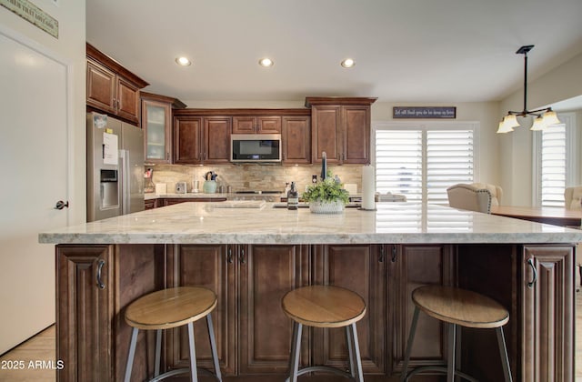 12041 S 45th St, Phoenix, AZ 85044 - kitchen with recessed lighting, decorative backsplash, a wealth of natural light, and stainless steel appliances