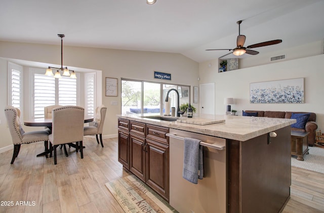 12041 S 45th St, Phoenix, AZ 85044 - kitchen featuring light wood-style floors, visible vents, lofted ceiling, stainless steel dishwasher, and a sink