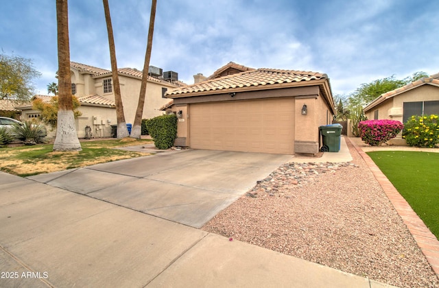 12041 S 45th St, Phoenix, AZ 85044 - mediterranean / spanish-style house with an attached garage, a tiled roof, concrete driveway, and stucco siding