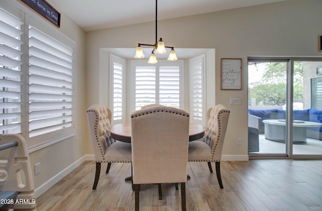 12041 S 45th St, Phoenix, AZ 85044 - dining room with baseboards, vaulted ceiling, a notable chandelier, and wood finished floors