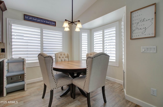 12041 S 45th St, Phoenix, AZ 85044 - dining room with baseboards, light wood finished floors, a chandelier, and lofted ceiling