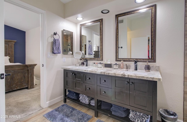 12041 S 45th St, Phoenix, AZ 85044 - bathroom with visible vents, wood finished floors, a sink, double vanity, and baseboards