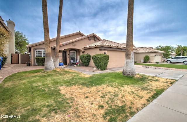 12041 S 45th St, Phoenix, AZ 85044 - mediterranean / spanish home featuring stucco siding, concrete driveway, a garage, and a front lawn