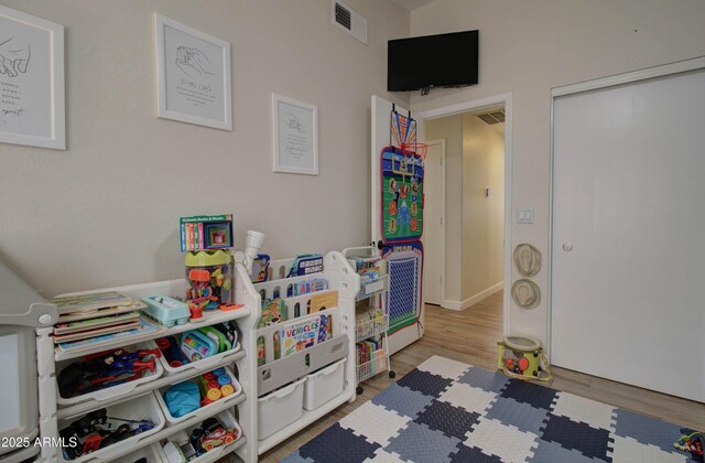 12041 S 45th St, Phoenix, AZ 85044 - rec room with visible vents and wood finished floors