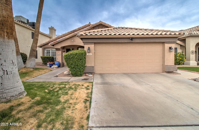 12041 S 45th St, Phoenix, AZ 85044 - mediterranean / spanish-style home with concrete driveway, stucco siding, a tiled roof, and an attached garage