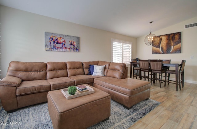 12041 S 45th St, Phoenix, AZ 85044 - living room featuring light wood-type flooring, vaulted ceiling, visible vents, a chandelier, and baseboards