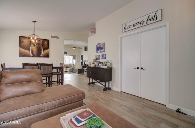12041 S 45th St, Phoenix, AZ 85044 - living area featuring ceiling fan with notable chandelier, light wood finished floors, baseboards, and visible vents