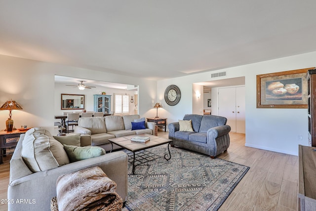 living room featuring light wood finished floors and visible vents