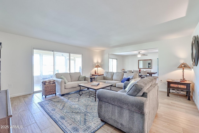 living area with light wood-style flooring and baseboards