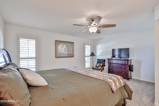 carpeted bedroom with a ceiling fan and baseboards