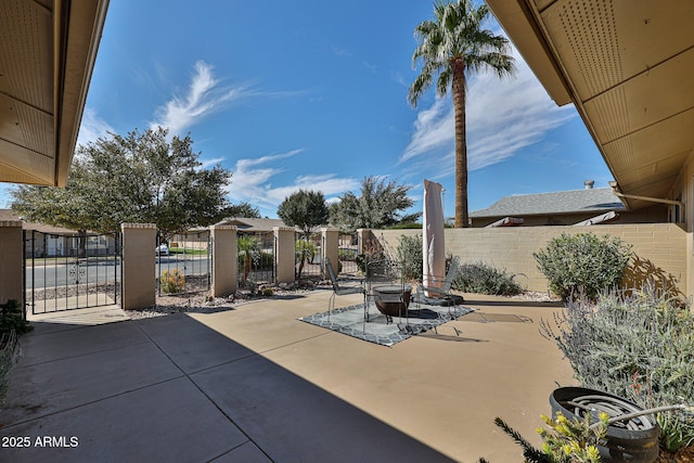 view of patio with a gate and fence