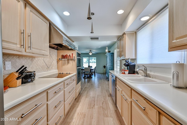 kitchen with visible vents, light brown cabinets, a sink, black appliances, and extractor fan