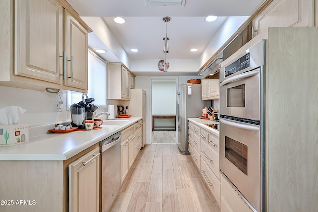 kitchen with recessed lighting, light countertops, visible vents, appliances with stainless steel finishes, and a sink