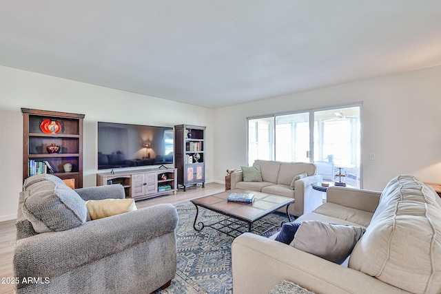 living room featuring light wood finished floors and baseboards