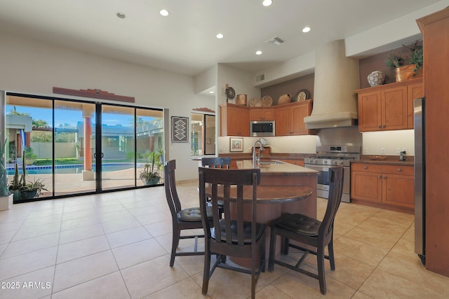 dining space with sink and light tile patterned flooring