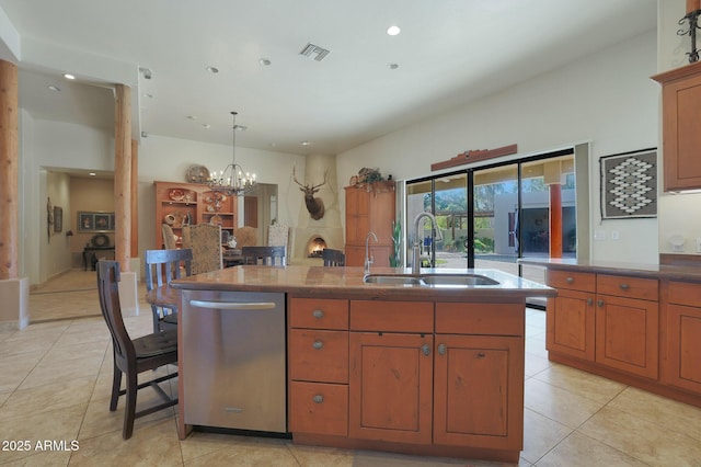 kitchen featuring sink, dishwasher, a kitchen island with sink, and light tile patterned flooring