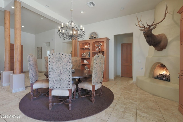 tiled dining area featuring a chandelier