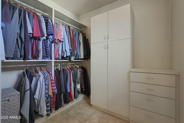 walk in closet with light tile patterned flooring