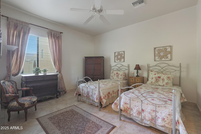 bedroom with ceiling fan and light tile patterned flooring