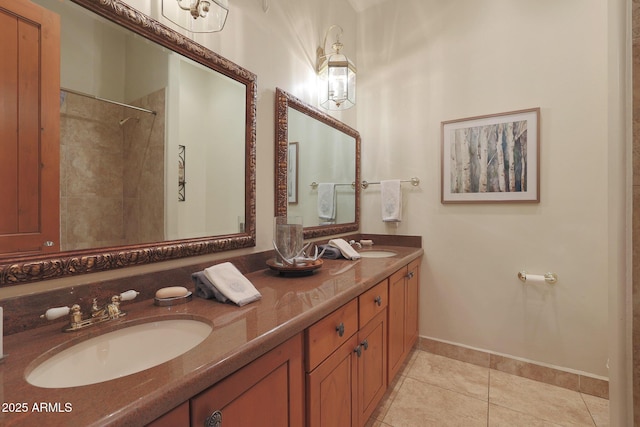 bathroom with tile patterned flooring, tiled shower, and vanity