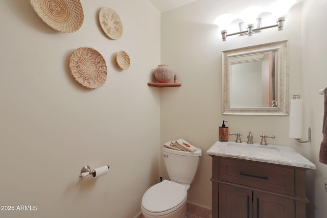 bathroom with toilet and vanity